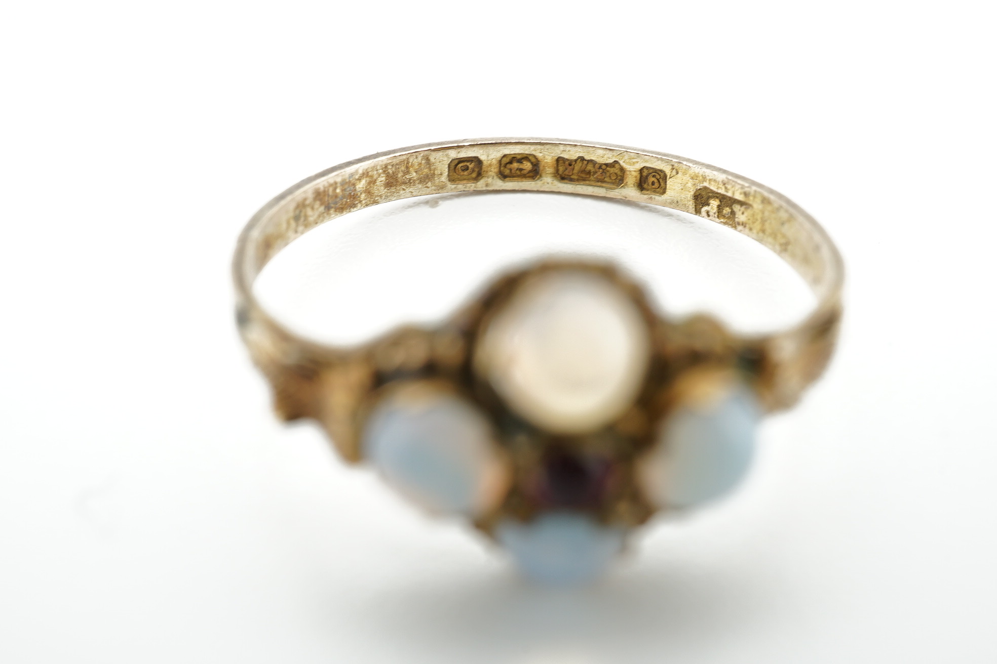 An early 20th century 9ct gold and opal cluster cluster set ring, size M, a 9ct and four(ex five) stone set opal half hoop ring and an 18ct and five stone diamond set half hoop ring. Condition - poor to fair